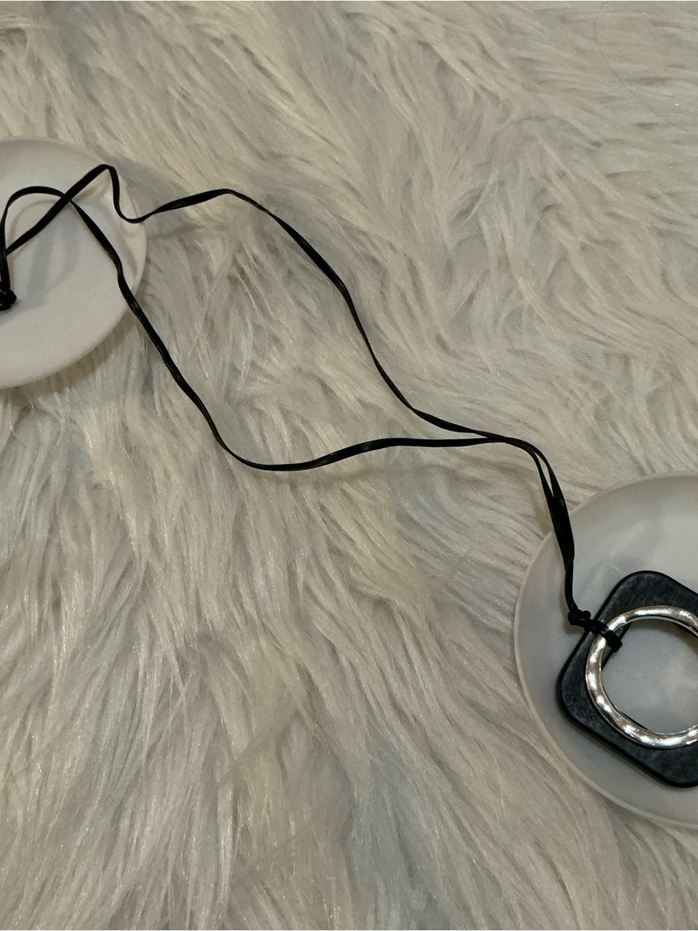 Square pendant necklace with silver ring on black cord